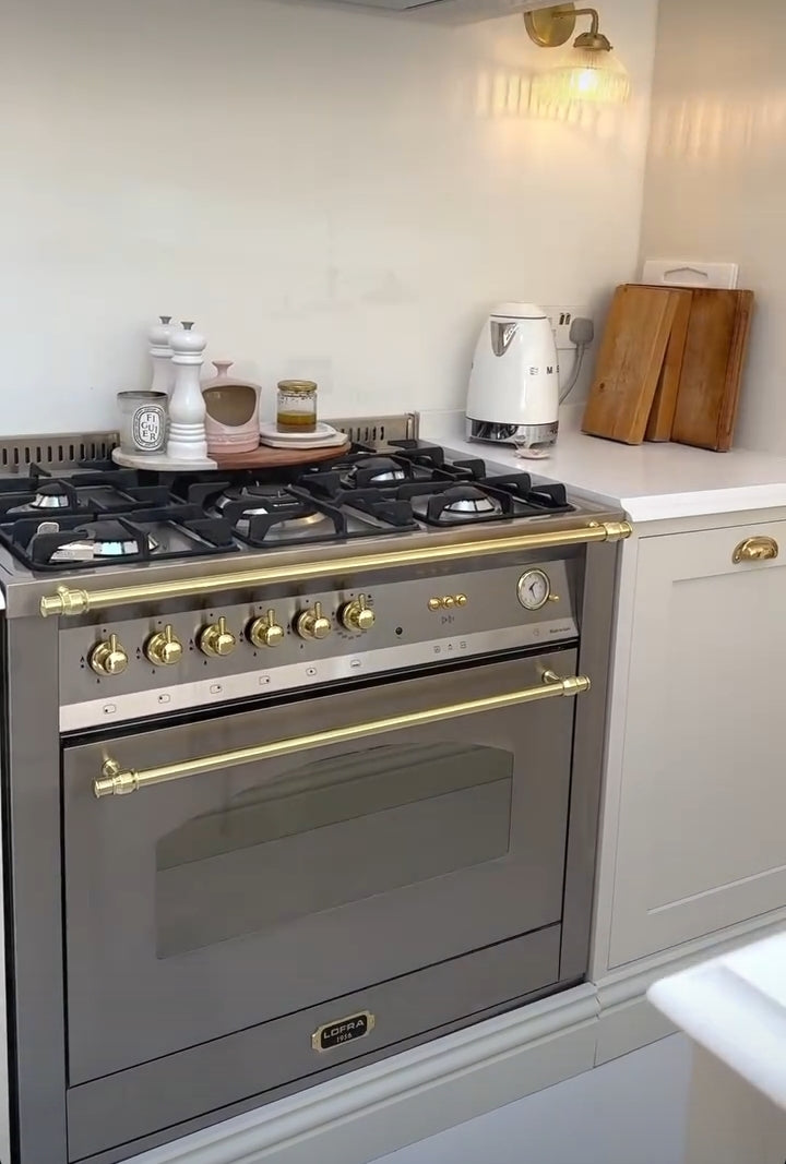 Lofra Stainless steel Integrated Range Cooker oven in a kitchen setting with a light background