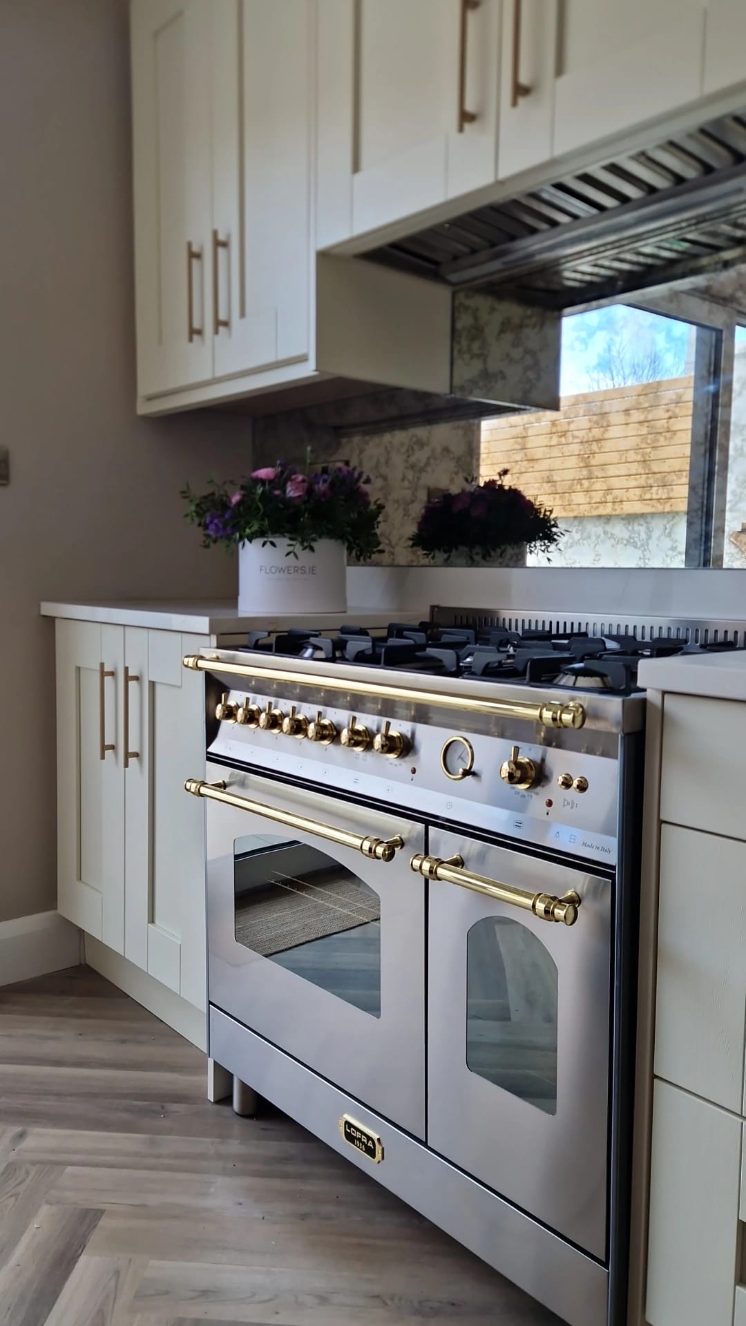 Stainless Steel Range Cooker with gold accents in a kitchen setting 