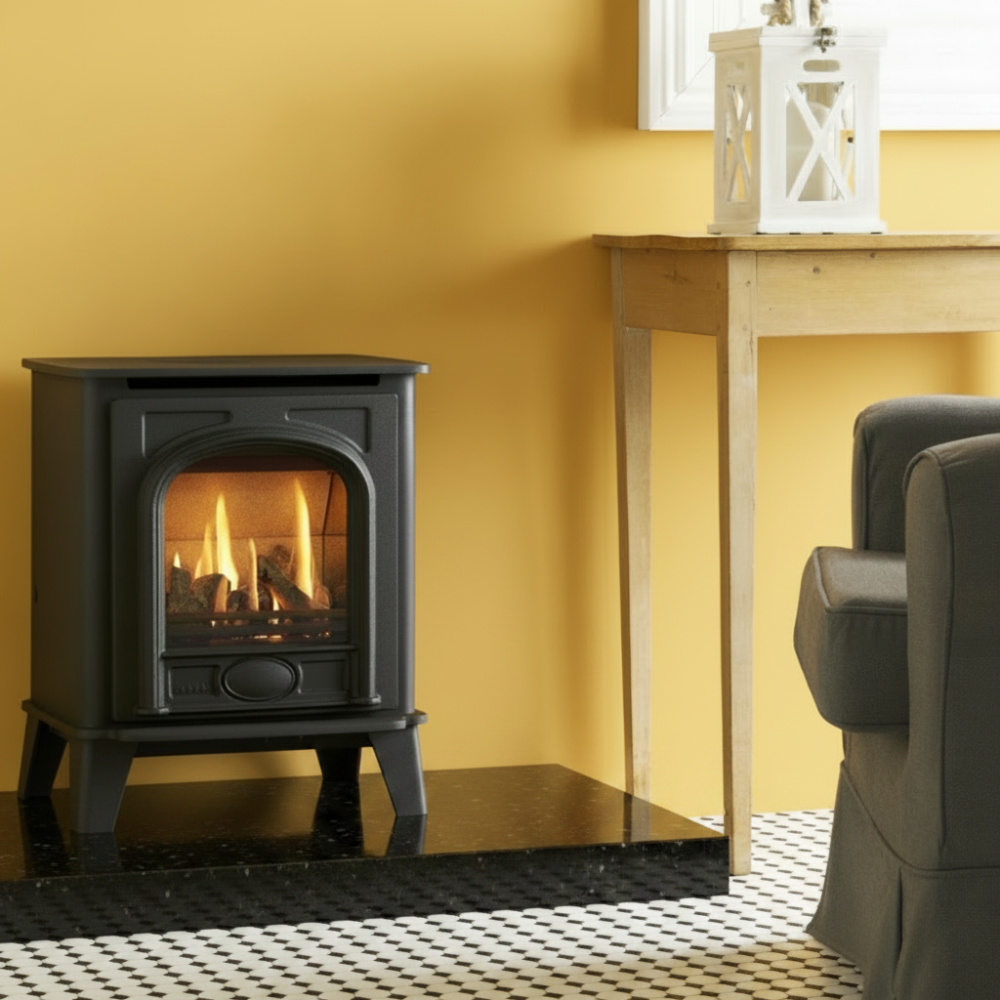Black Gazco Small Stockton 2 freestanding stove on a wooden platform with a neutral background