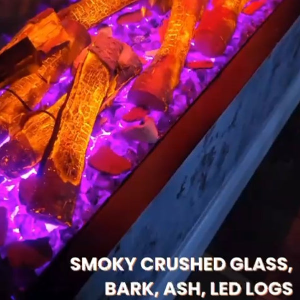 Aquarium with smoky crushed glass, bark, ash, and LED logs under purple lighting.