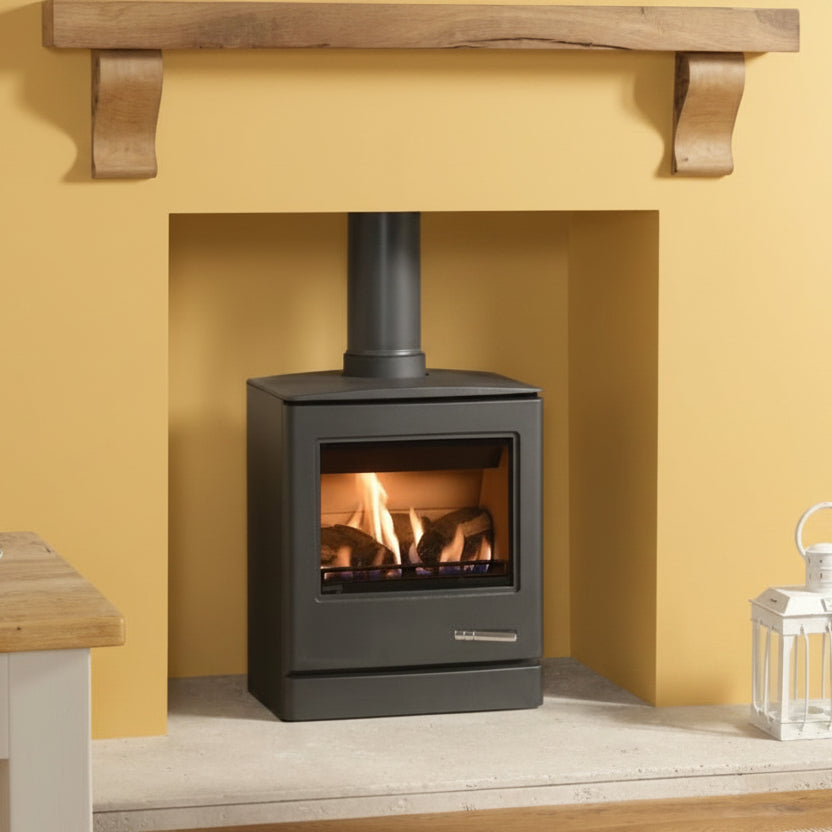 Modern Yoeman Cl5 Gas Stove in a fireplace with wooden mantel and table.