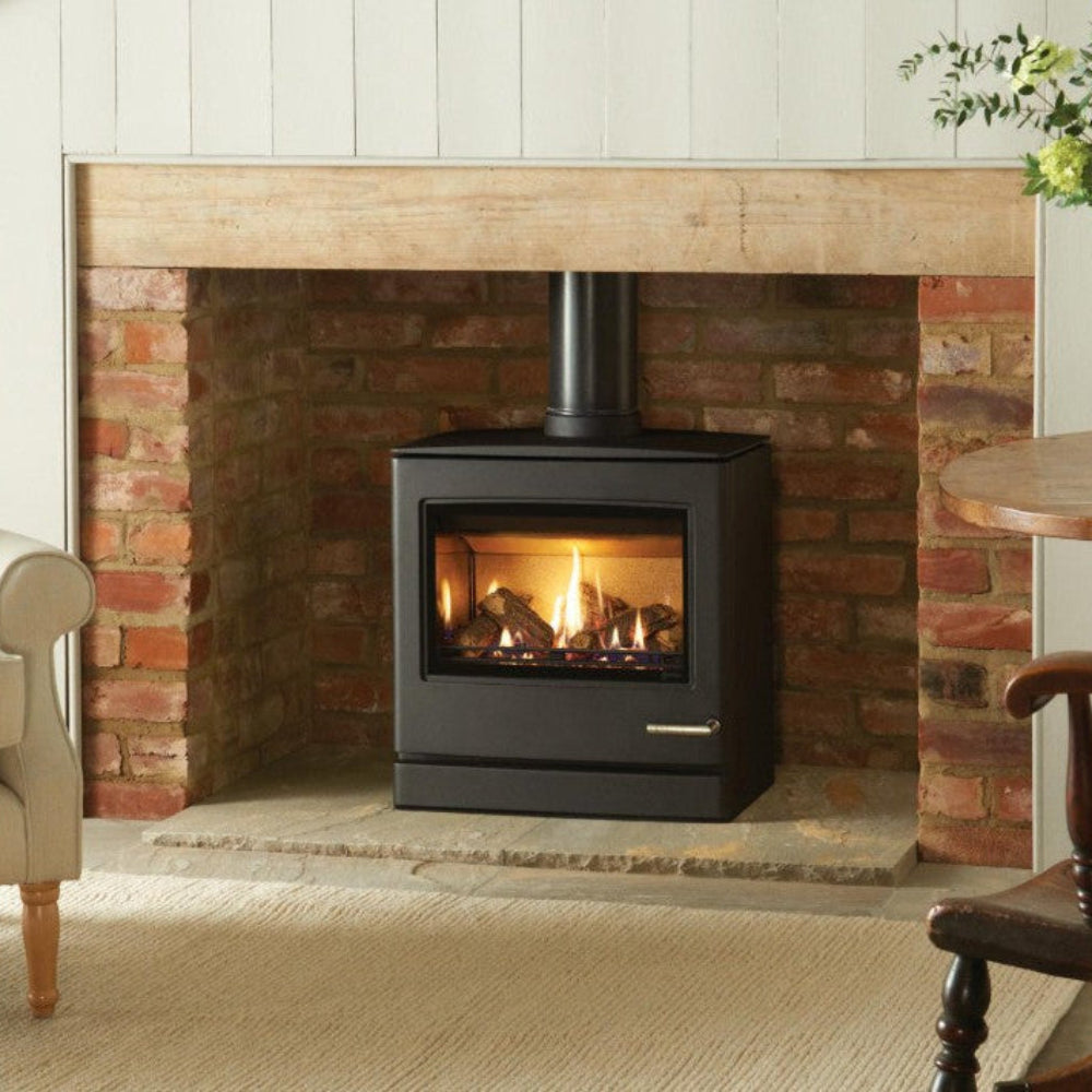 Living room with a fireplace, chair, and table with flowers with CL8 Larger Model.