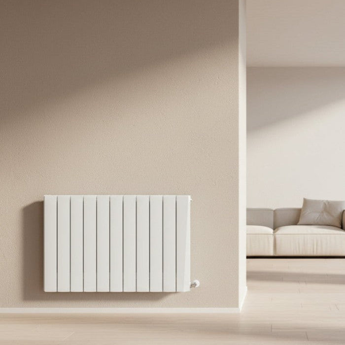 White radiator on a beige wall with a modern living room setting Smart Electric Radiators Heat Design Range the Energy Efficient Electric Heating for Ireland
