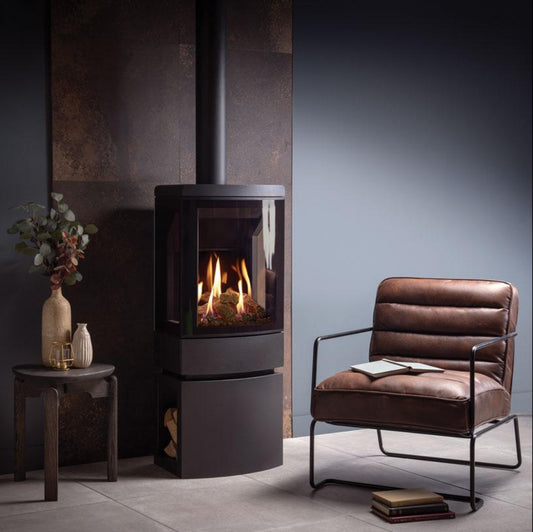 Modern Gazco Gas Loft wood stove in a room with a brown chair and small table