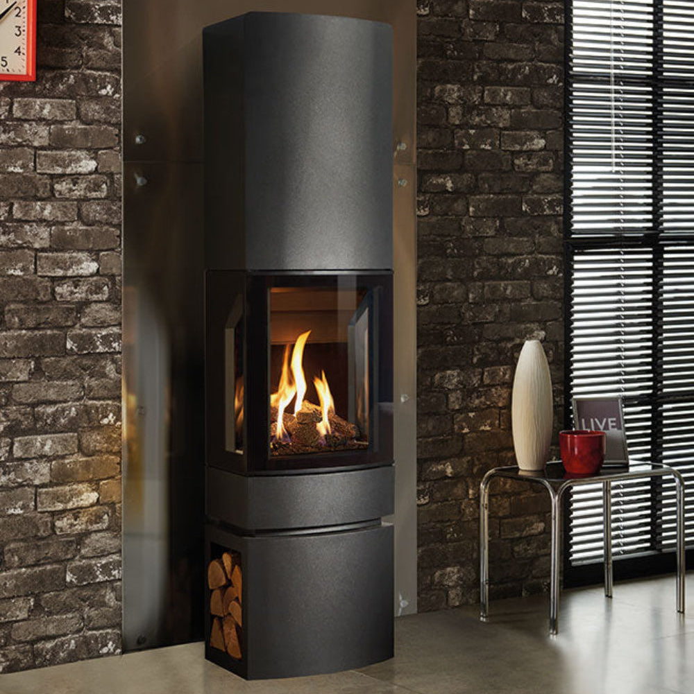 Modern wood-burning stove in a room with stone walls and a rug Loft with Steel Log Base and Tall Top
