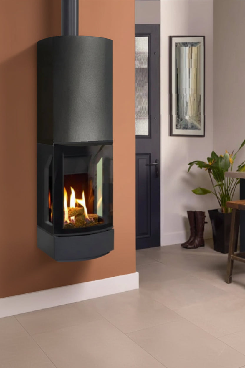 Modern Lofra Balanced Flue Gas Stove graphite freestanding gas stove in a room with a plant and stool. Terracotta and cream