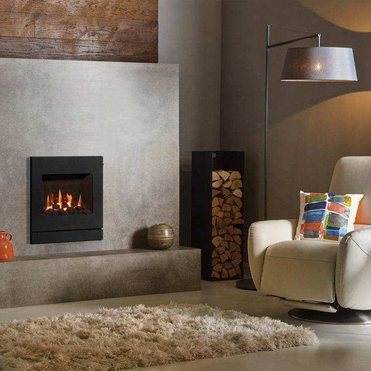 Modern living room with a fireplace, armchair, and decorative items.