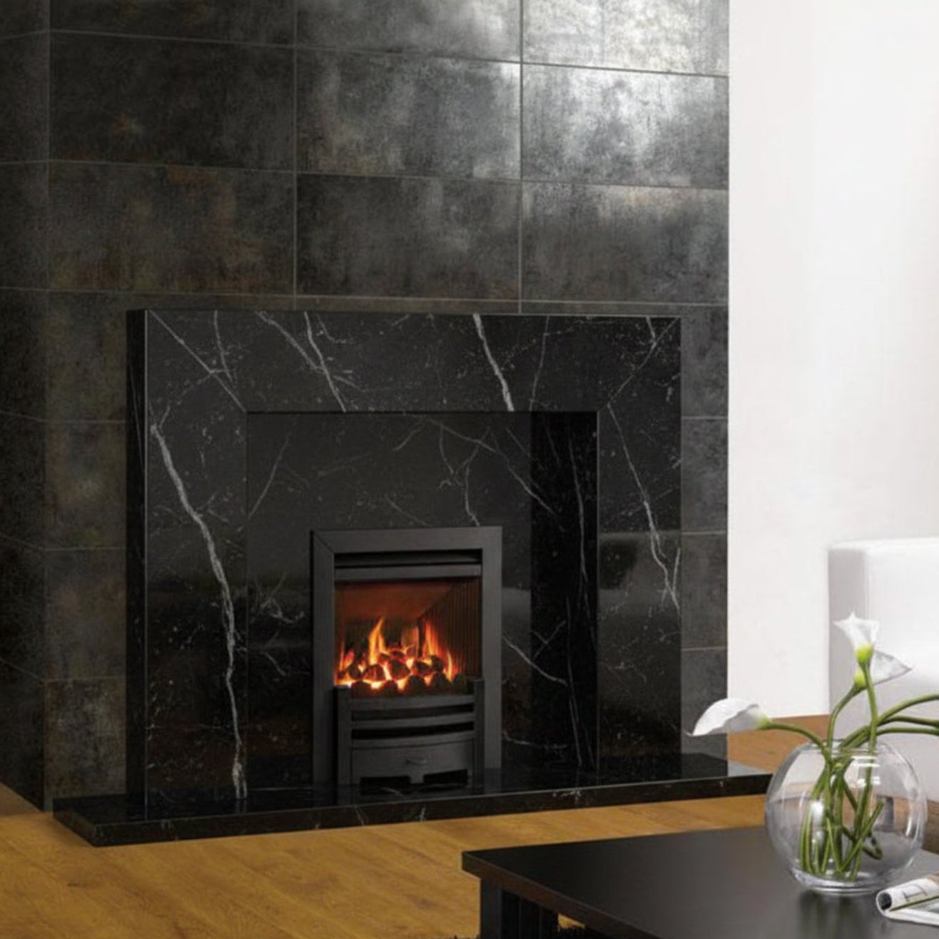 Modern living room with a Black Marble fireplace, white sofa, and coffee table fitted with a Faqs on the Gazco Logic He High Efficiency Gas Arts He Fire In Black