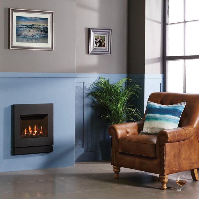 Modern living room with a gas fireplace, leather chairs, and decorative elements.