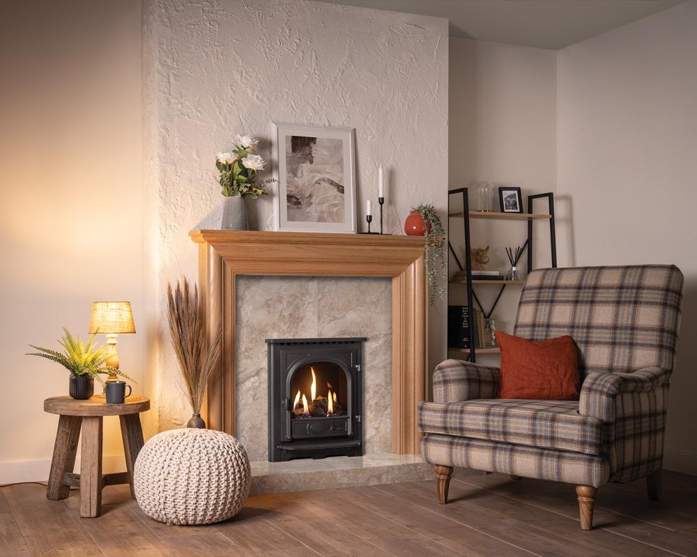 Cozy living room with fireplace, armchair, and decorative items with Gazco Stockton Gas Fire 