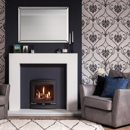 Living room with a fireplace, gray chairs, and decorative pillows against patterned wallpaper.