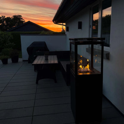 Bottled Gas Outdoor Patio Heater with real flame glass log effect- Murcia Flame Heater at night on back garden terrace patio