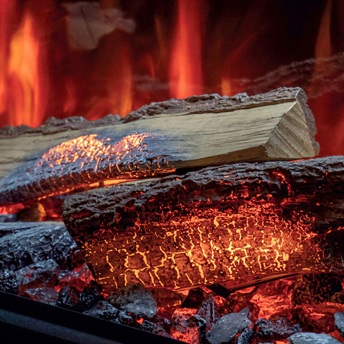 Close-up of realistic artificial logs with glowing embers and flames, shown as a fireplace-style product detail shot.