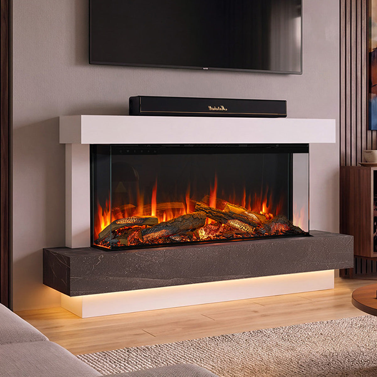 A modern electric 120 Turin fireplace with a white mantel and dark stone base, featuring glowing orange flames and faux logs inside a glass front. A black Marshall soundbar sits on the mantel, and the fireplace is installed in a contemporary living room setting.