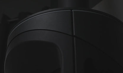 Close-up of a dark-colored cylindrical object with a textured surface of the Onyx Liv 3 Gas Stove High Efficiency Gas Stove Ireland Contemporary Log Effect Gas Stove