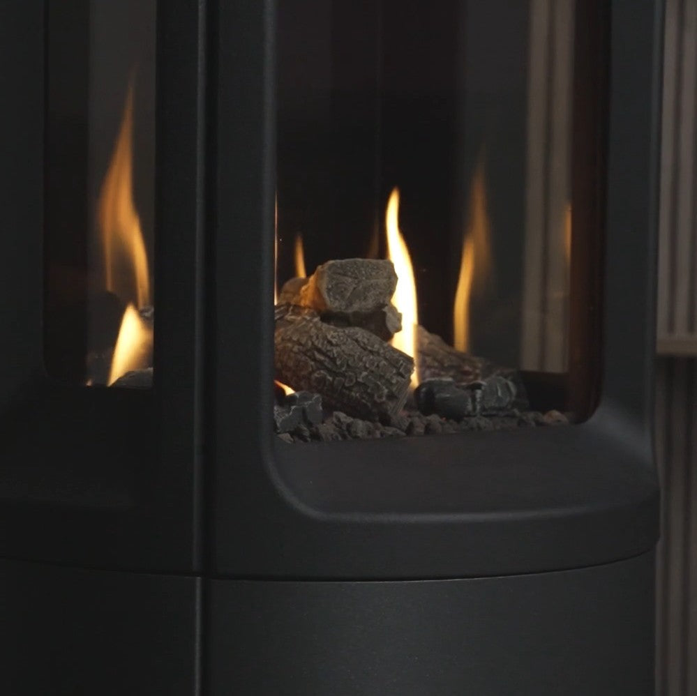 Close-up of a modern fireplace with flames and logs inside from the Onyx Liv 3 Gas Stove High Efficiency Gas Stove Ireland Contemporary Log Effect Gas Stove
