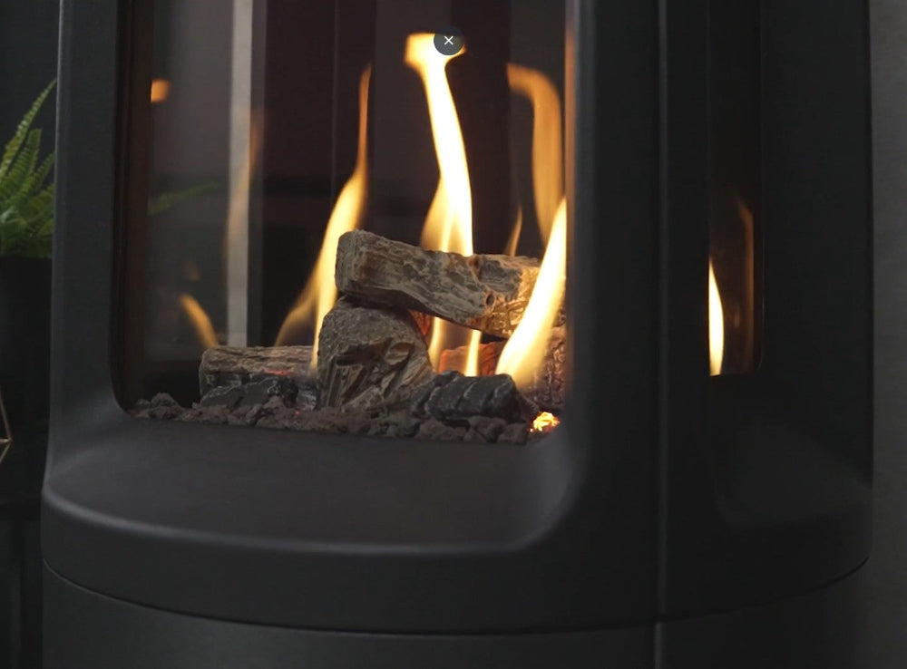 Close-up of a gas fireplace with flames and logs inside from the Onyx Liv 3 Gas Stove High Efficiency Gas Stove Ireland Contemporary Log Effect Gas Stove