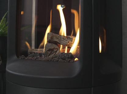 Close-up of a gas fireplace with flames and logs inside from the Onyx Liv 3 Gas Stove High Efficiency Gas Stove Ireland Contemporary Log Effect Gas Stove