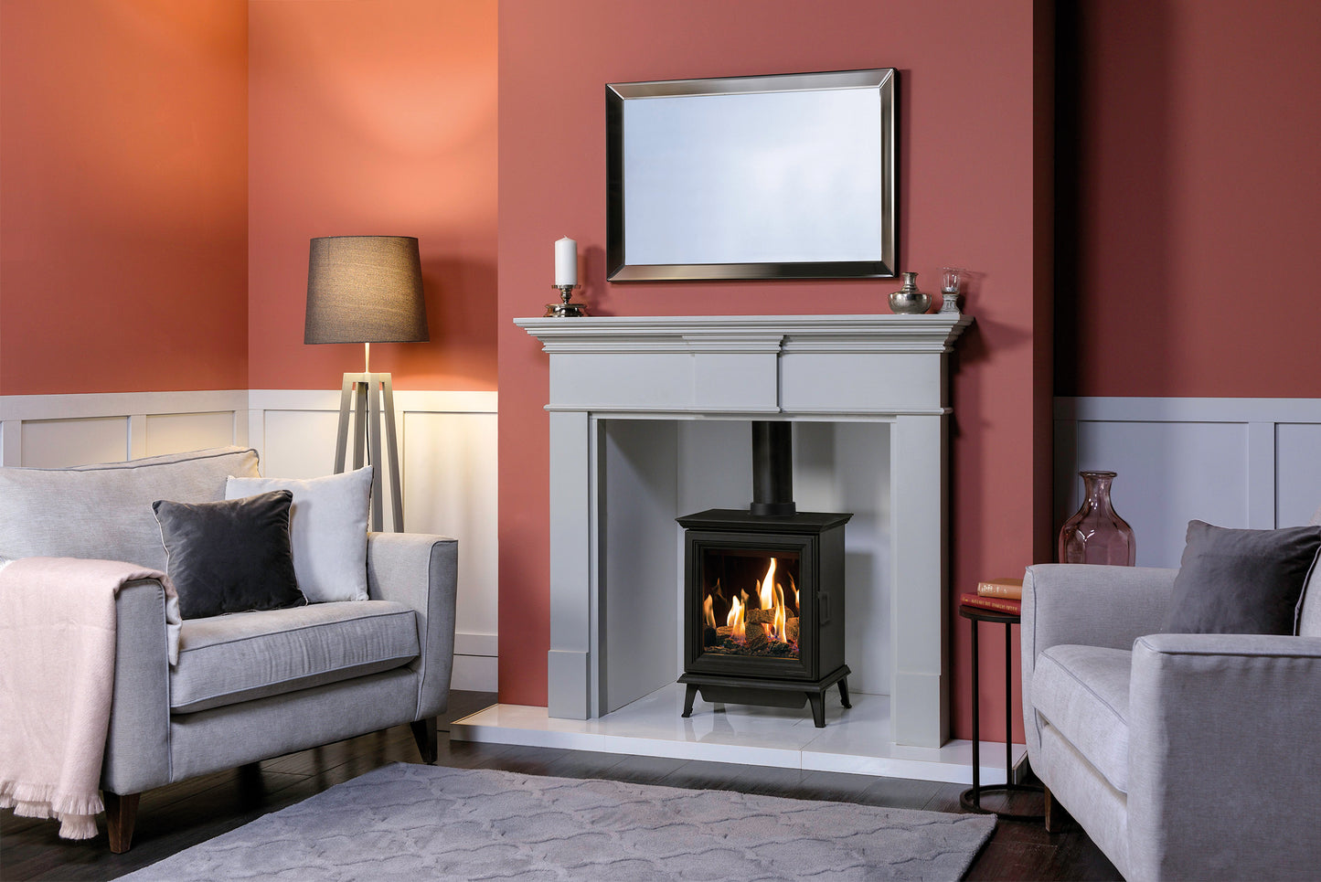 Gazco Sheraton Gas Stove in a Living room with a fireplace, gray sofa, and red walls 
