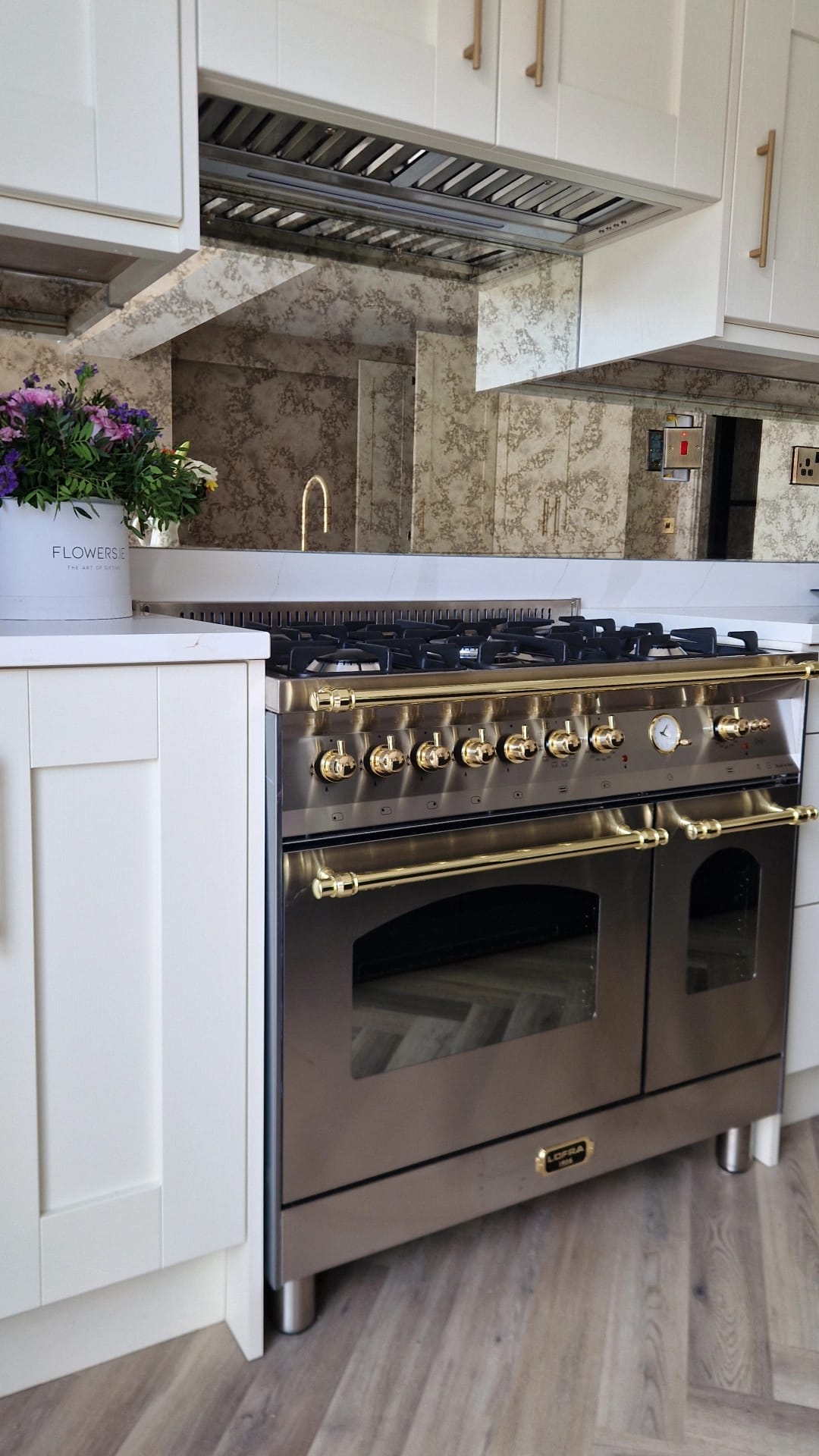 Stainless steel Range Cooker with gold accents in a kitchen setting