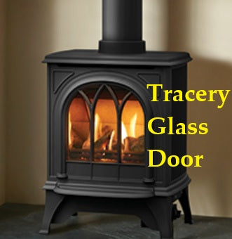 Black stove with tracery glass door in a room setting