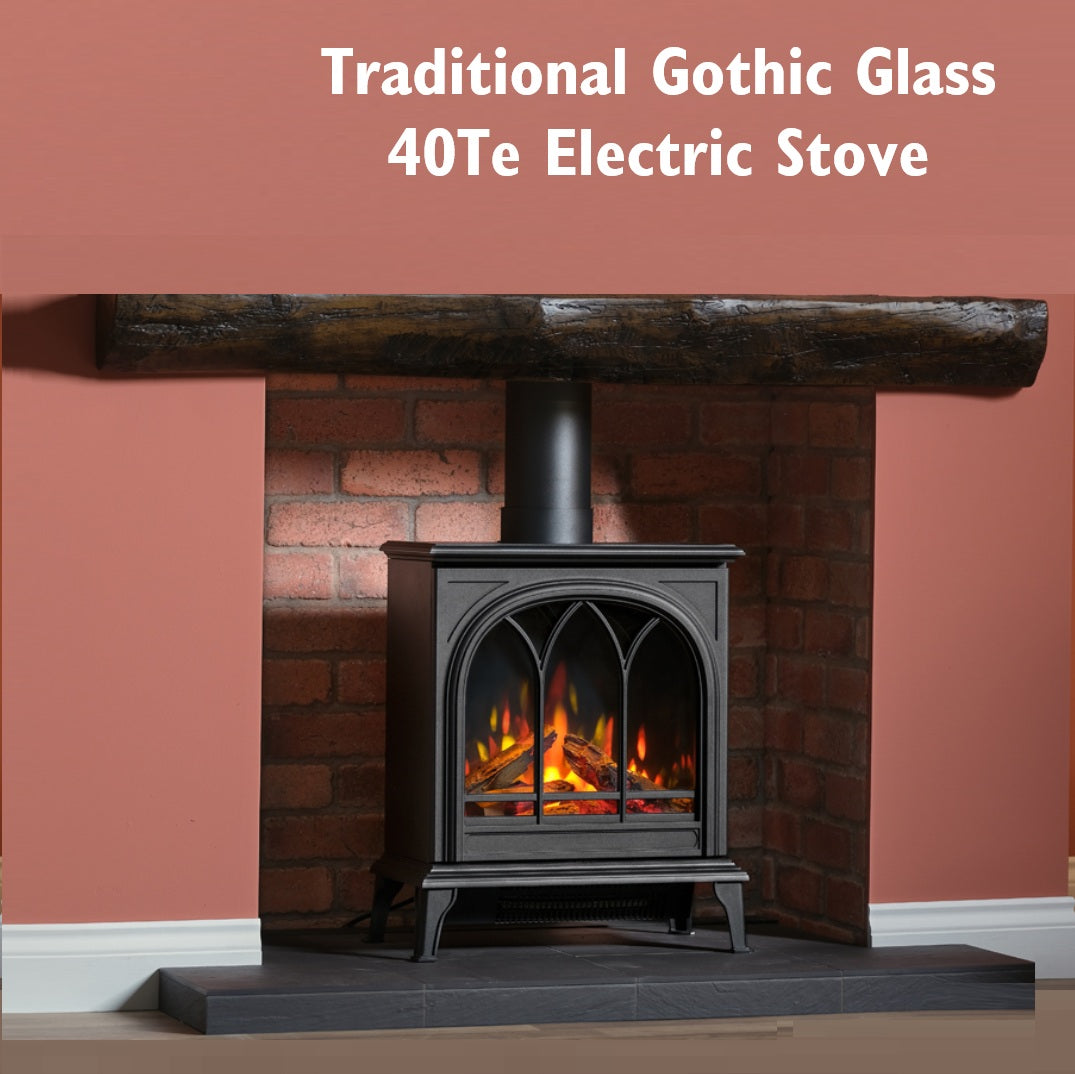 Traditional Gothic Glass 40Te Electric Stove with flames inside, placed against a brick wall.