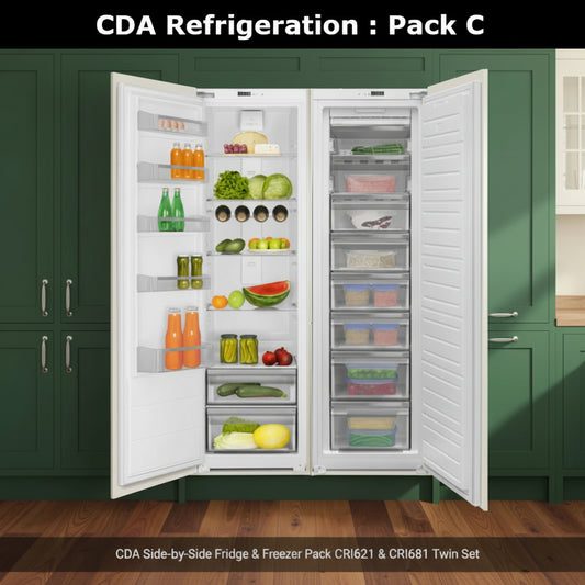 A CDA white side-by-side Integrated full larder refrigerator shown with full frost free full freezer, shown with both doors open, stocked with food and beverages. The left door contains shelves with orange bottles, green drinks, and produce, while the right door features a vertical freezer compartment with clear storage drawers containing frozen items 