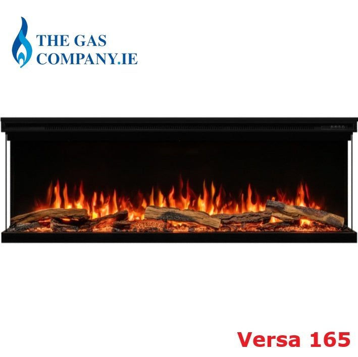 A black electric Atmos Fire FX Versa fireplace insert with glowing orange and yellow flames and faux logs, shown against a white background with 'THE GAS COMPANY.IE' logo at top left and 'Versa 165' text at bottom right.