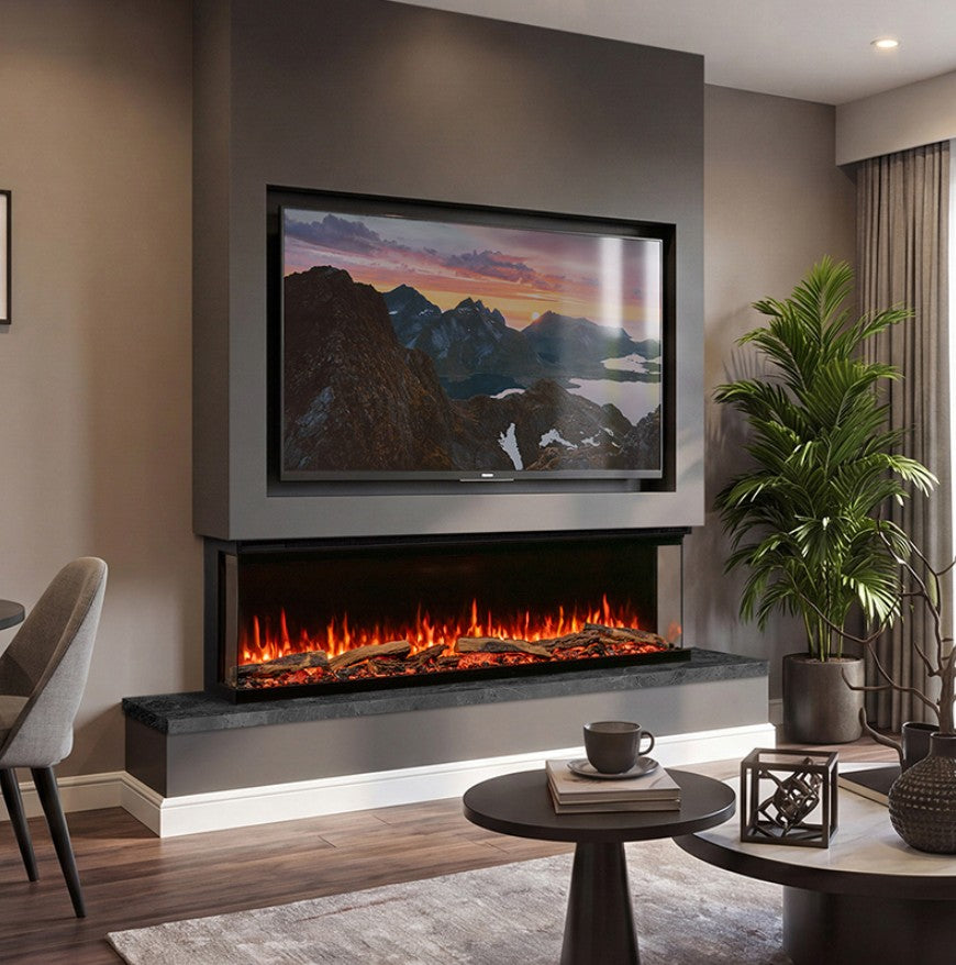 A modern wall-mounted electric Atmos Fx Versa 165w fireplace with a black frame and glowing orange flames, set into a dark gray wall above a built-in shelf. A large framed mountain landscape print is displayed on the wall above the fireplace.