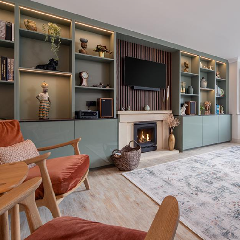 Living room with a fireplace, shelves, and a TV
