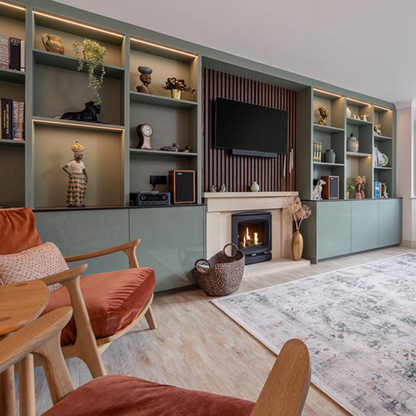 Living room with a fireplace, shelves, and a TV