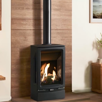 Gazco Midi T Modern freestanding stove with flames inside, placed against a wooden wall in a room.