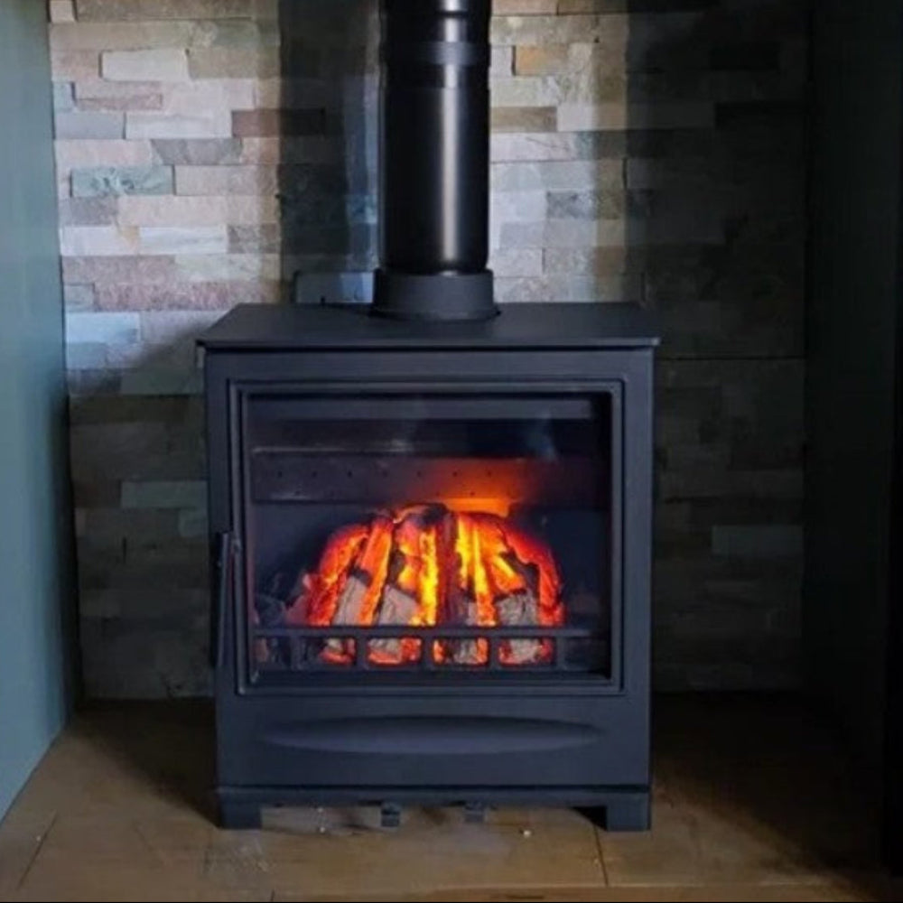 Black KeepHerLit electric inset fire FAKE FLAME INSET fitted inside a freestanding 5 Kilowatt solid fuel stove , show with glowing interior flames against a stone wall.