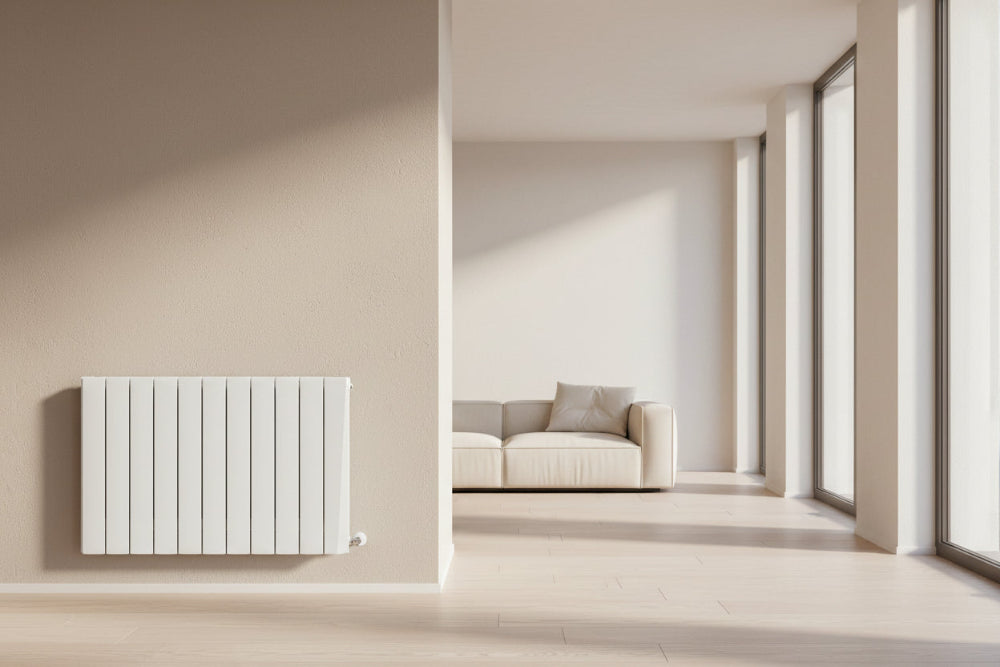 Modern radiator on a beige wall next to a sofa in a minimalistic living room. Smart Electric Radiators Heat Design Range the Energy Efficient Electric Heating for Ireland