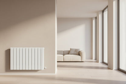 Modern radiator on a beige wall next to a sofa in a minimalistic living room. Smart Electric Radiators Heat Design Range the Energy Efficient Electric Heating for Ireland