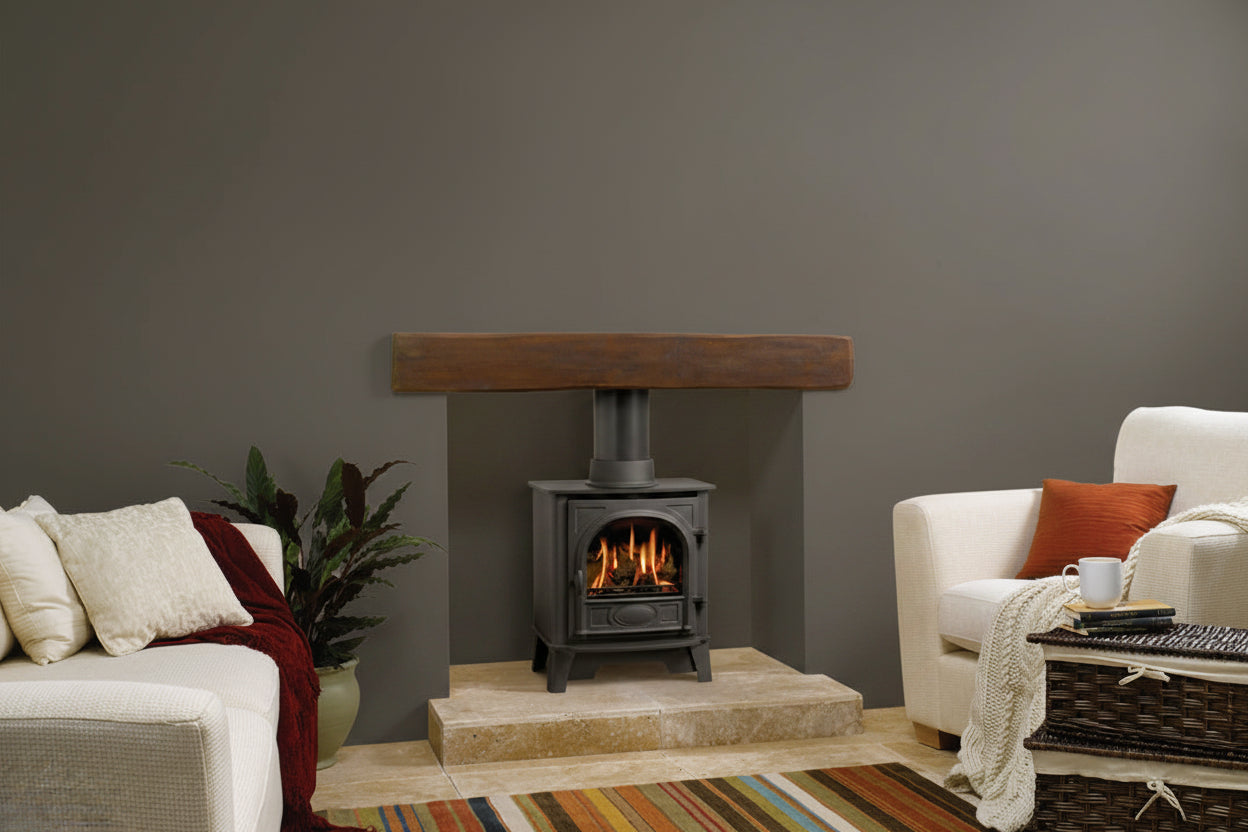 Gazco Stockton 5 Balanced Flue Gas Stove in cream sofa Living room with a fireplace, sofa, and striped rug.
